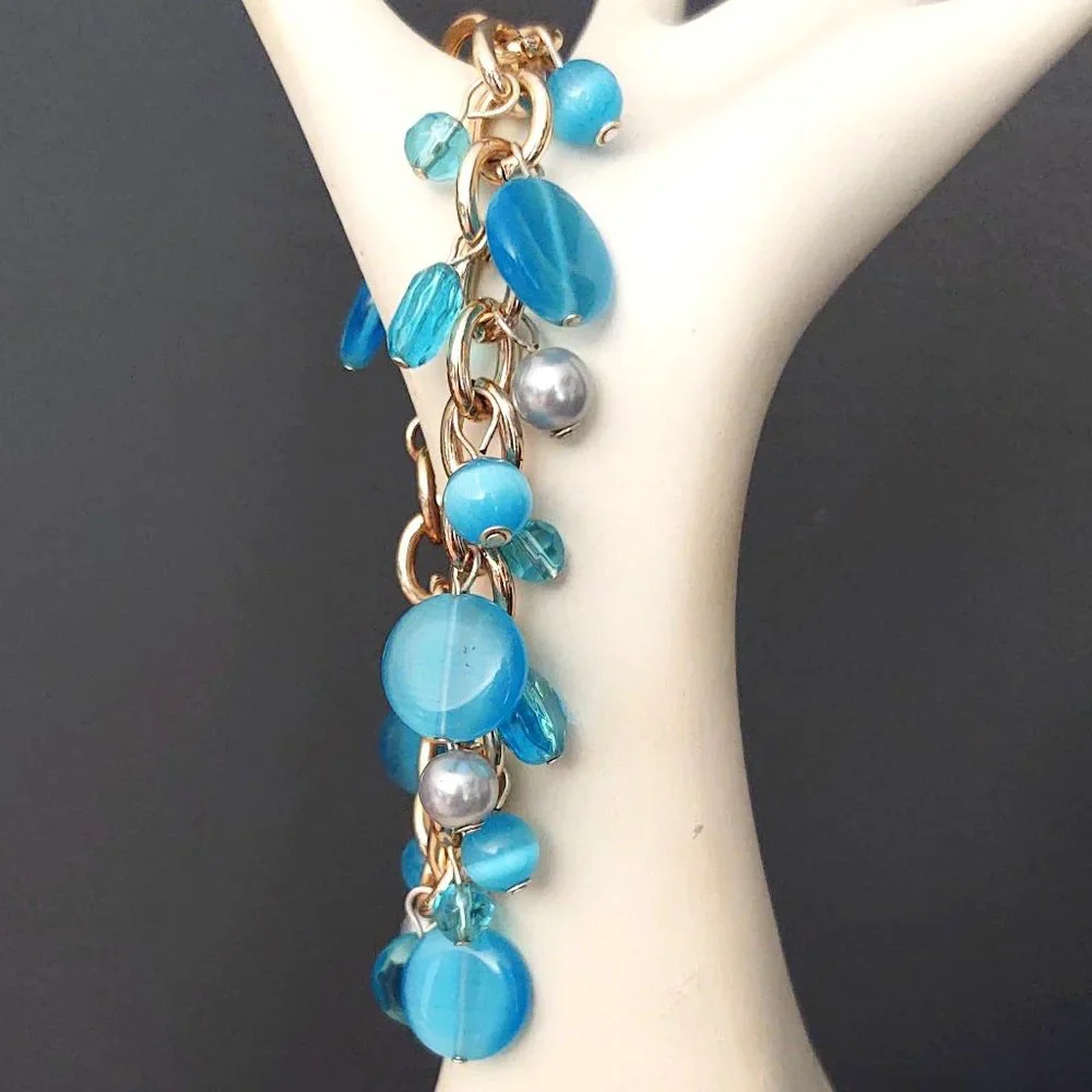 Blue bead and faux pearl charm style bracelet